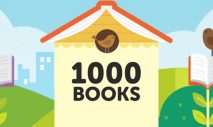 A cartoon-style picture with the text "1000 BOOKS" printed in big black letters on the front of a yellow birdhouse. The roof is an open, upturned book. The background includes grassy hills and birds and a bee and flowers with open books as the blooms. A city skyline is in the far background with a blue sky and clouds.